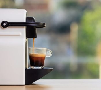 Espresso Coffee Machine On A Wooden Table, Blur Background, Space For Text