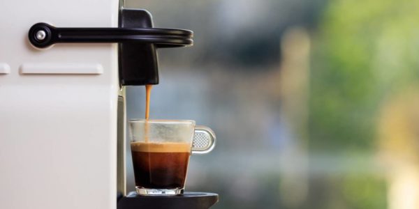 Espresso Coffee Machine On A Wooden Table, Blur Background, Space For Text